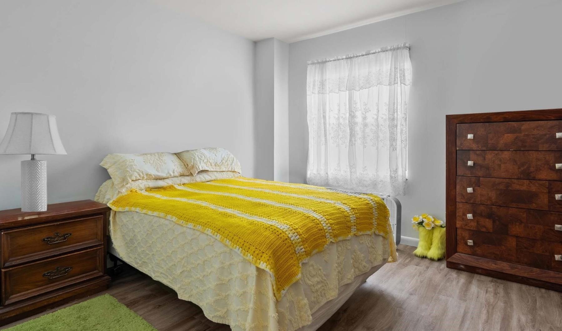 a bedroom with a bed and dresser